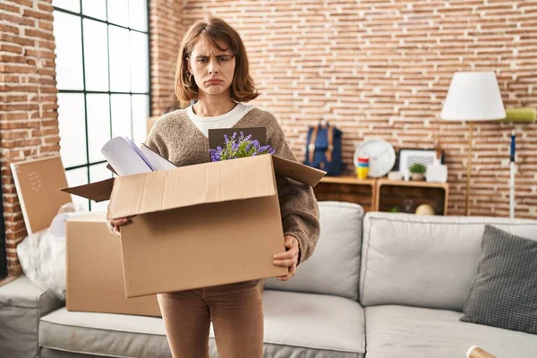 Young Beautiful Woman Holding Box Moving New Home Depressed Worry — Stockfoto