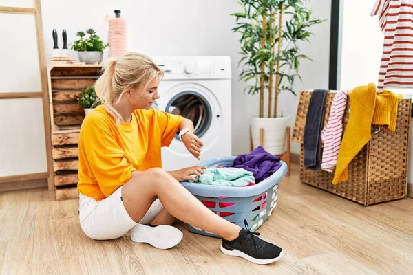 Young Caucasian Woman Putting Dirty Laundry Washing Machine Checking Time — Stockfoto