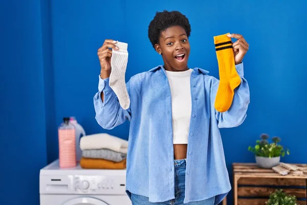 African American Woman Holding Clean Andy Dirty Socks Celebrating Crazy — Stockfoto