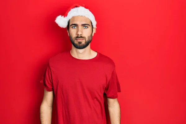 Young Hispanic Man Wearing Christmas Hat Relaxed Serious Expression Face — Stockfoto