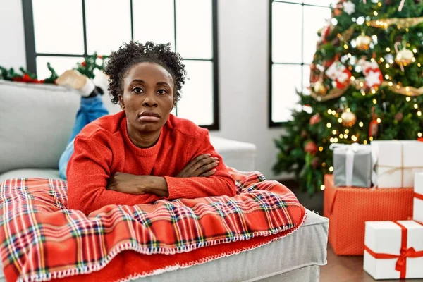 Young African American Woman Lying Sofa Christmas Tree Relaxed Serious — Stockfoto