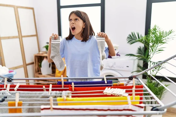 Young Hispanic Girl Hanging Socks Clothline Angry Mad Screaming Frustrated — Foto Stock