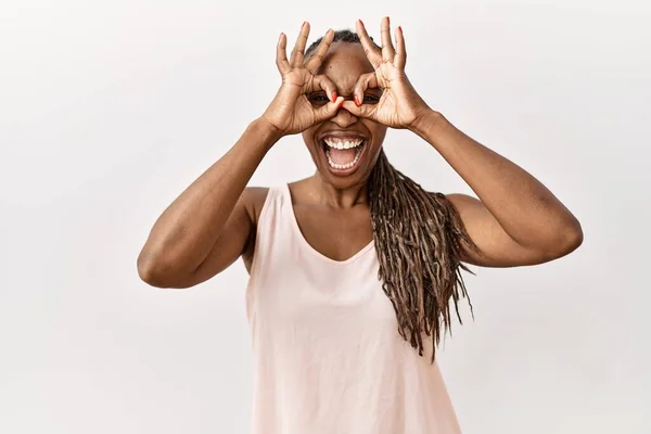 Black Woman Braids Standing Isolated Background Doing Gesture Binoculars Sticking — стоковое фото
