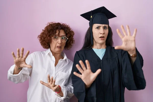 Hispanic Mother Daughter Wearing Graduation Cap Ceremony Robe Afraid Terrified — Foto de Stock