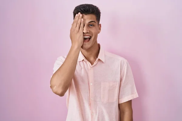 Young Hispanic Man Standing Pink Background Covering One Eye Hand — Stockfoto