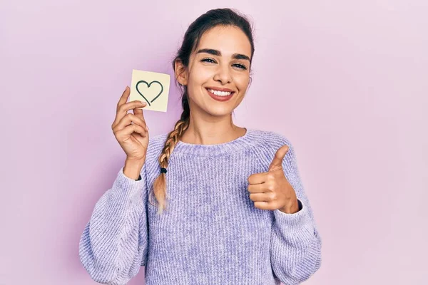 Young Hispanic Girl Holding Heart Reminder Smiling Happy Positive Thumb — Foto Stock