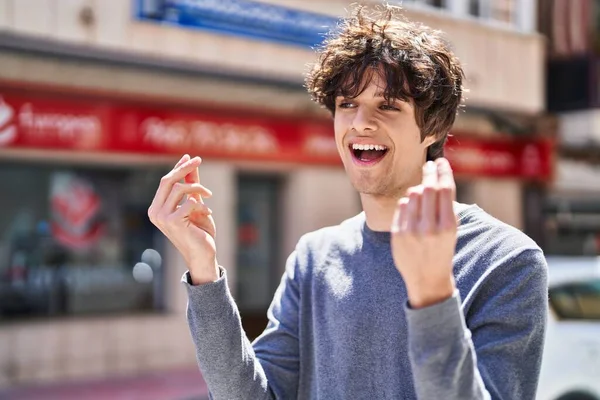 Young Hispanic Man Smiling Confident Doing Spend Money Gesture Street — Fotografia de Stock