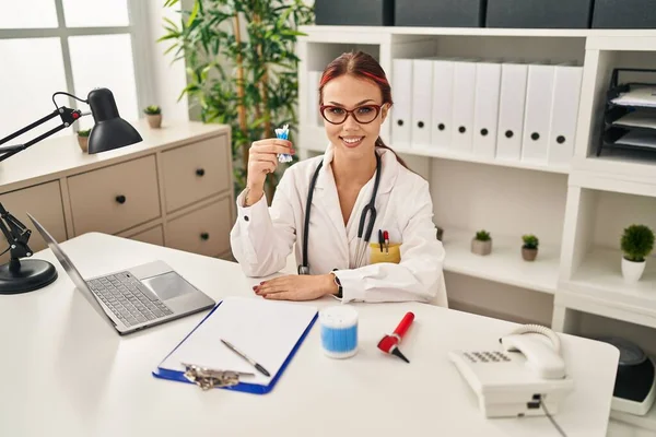 Young Caucasian Woman Wearing Doctor Uniform Holding Cotton Buds Looking — Stock Photo, Image