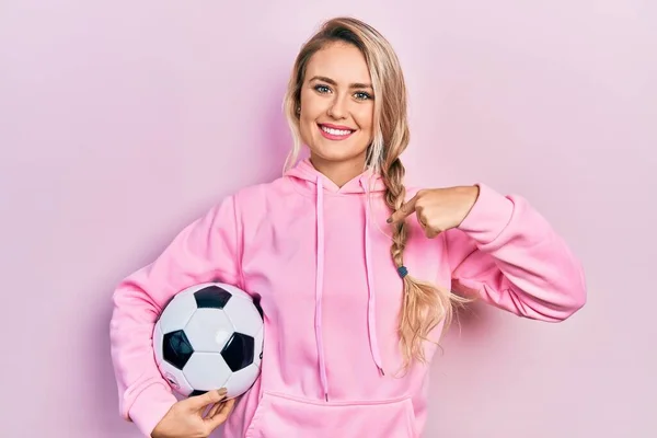 Beautiful Young Blonde Woman Holding Soccer Ball Pointing Finger One — Stok fotoğraf