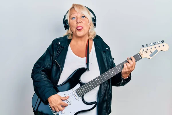 Middle Age Blonde Woman Playing Electric Guitar Using Headphones Sticking — Stok fotoğraf
