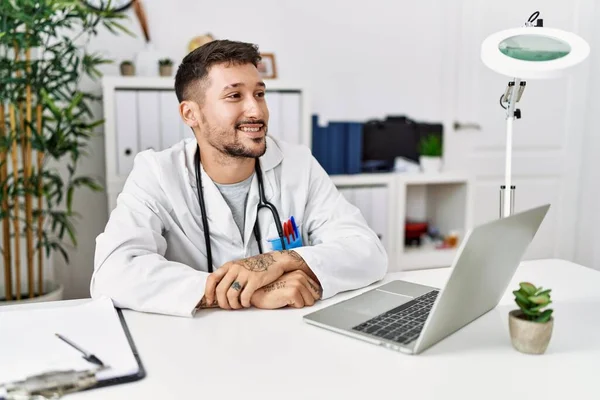 Young Doctor Working Clinic Using Computer Laptop Looking Away Side — Photo