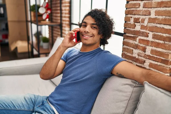 Young Hispanic Man Talking Smartphone Sitting Sofa Home — Stock Photo, Image