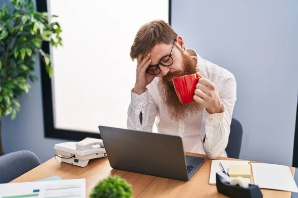 Young Redhead Man Business Worker Drinking Coffee Tired Expression Office — 스톡 사진