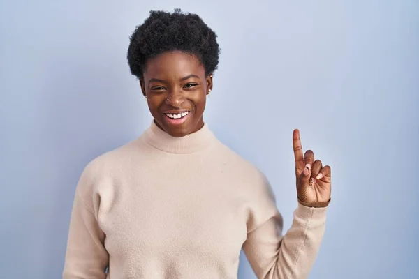 African American Woman Standing Blue Background Showing Pointing Finger Number — Fotografia de Stock