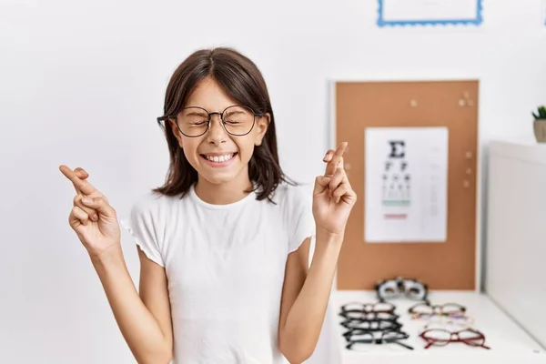 Young Hispanic Girl Wearing Glasses Gesturing Finger Crossed Smiling Hope — Fotografia de Stock