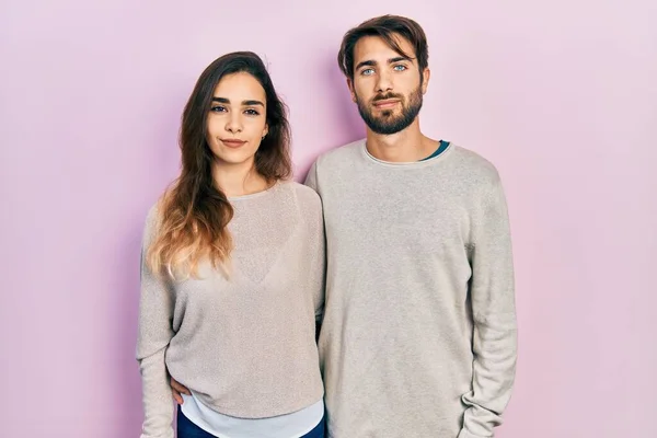 Young Hispanic Couple Wearing Casual Clothes Relaxed Serious Expression Face — Stock fotografie