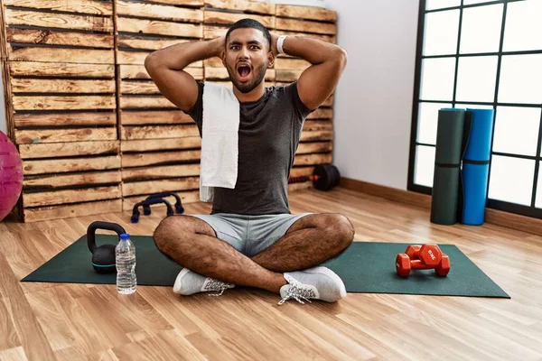 Young Indian Man Sitting Training Mat Gym Crazy Scared Hands — Stockfoto