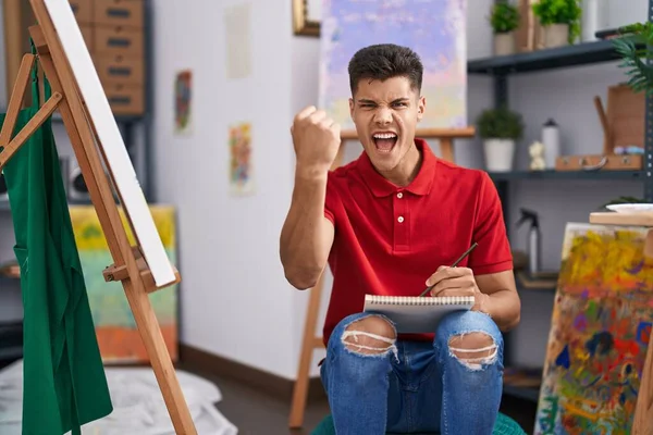 Young Hispanic Man Drawing Art Notebook Annoyed Frustrated Shouting Anger — Stockfoto