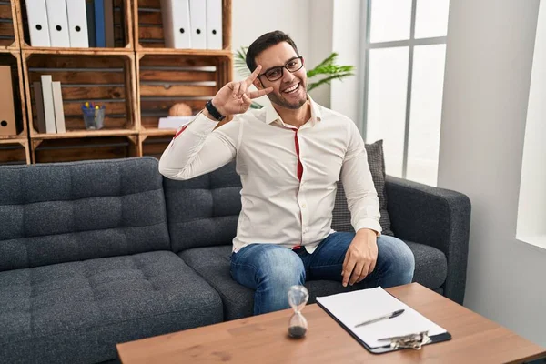 Young Hispanic Man Beard Working Consultation Office Doing Peace Symbol — Stock Photo, Image