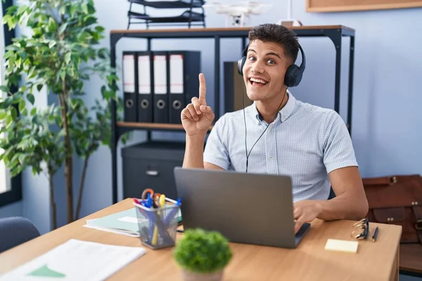 Young Hispanic Man Working Office Wearing Headphones Pointing Finger Successful — Stockfoto