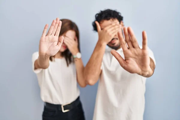 Young Couple Wearing Casual Clothes Standing Together Covering Eyes Hands — Stockfoto
