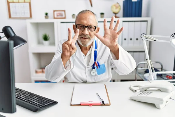 Mature Doctor Man Clinic Showing Pointing Fingers Number Seven While — 스톡 사진