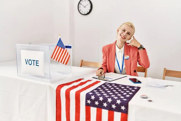 Beautiful caucasian woman working at political campaign smiling doing phone gesture with hand and fingers like talking on the telephone. communicating concepts.