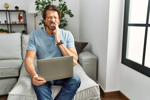 Handsome Middle Age Man Using Computer Laptop Sofa Touching Mouth — Stok fotoğraf