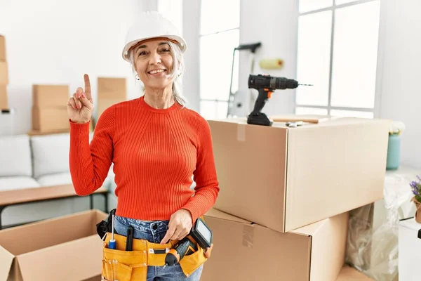 Middle Age Grey Haired Woman Wearing Hardhat Standing New Home — Stockfoto