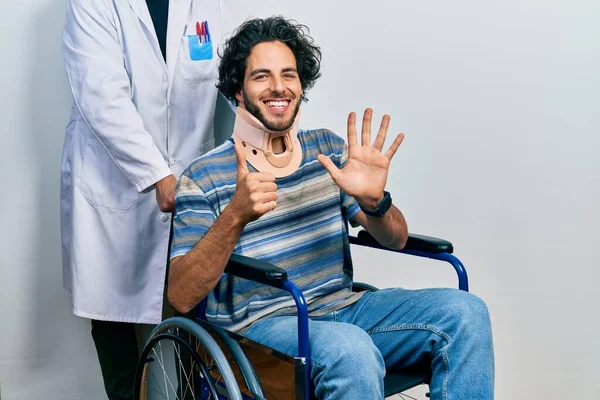 Handsome Hispanic Man Sitting Wheelchair Wearing Neck Collar Showing Pointing — Stock Photo, Image