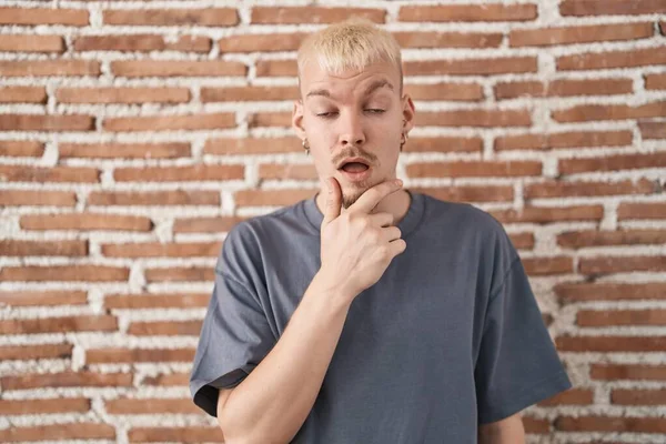 Young Caucasian Man Standing Bricks Wall Looking Fascinated Disbelief Surprise —  Fotos de Stock