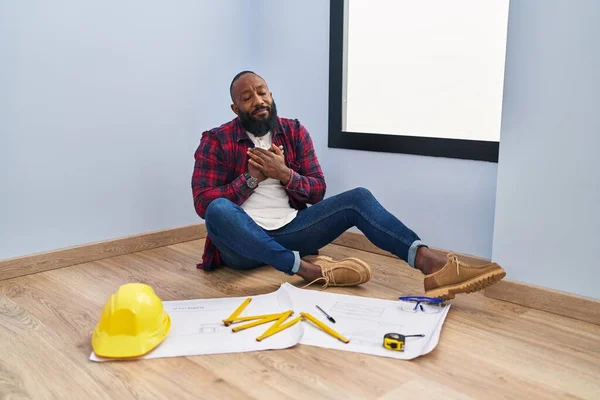 African American Man Sitting Floor New Home Looking Blueprints Smiling — Stock Photo, Image