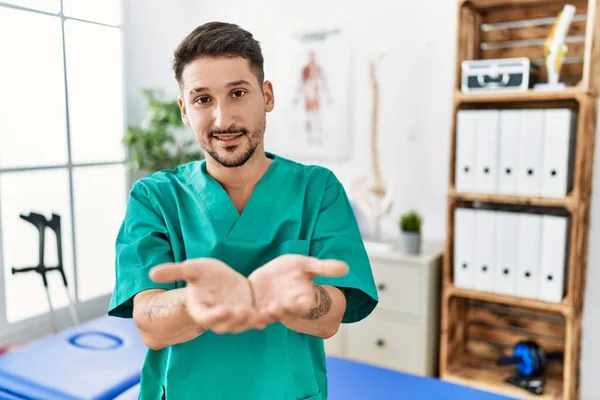 Young Physiotherapist Man Working Pain Recovery Clinic Smiling Hands Palms — Stockfoto