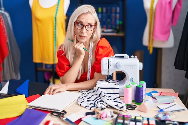 Young Blonde Woman Tailor Stressed Using Sewing Machine Sewing Studio — Stockfoto