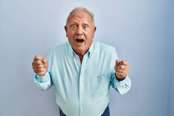 Senior Man Grey Hair Standing Blue Background Celebrating Surprised Amazed — Stok fotoğraf