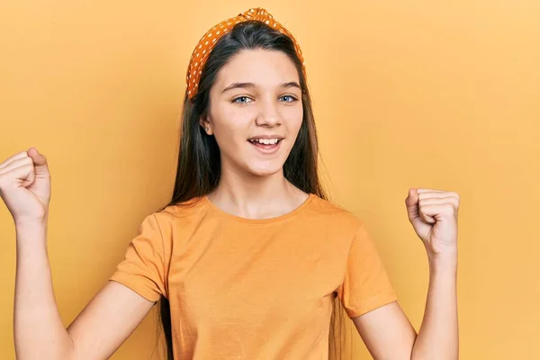 Young Brunette Girl Wearing Casual Orange Shirt Screaming Proud Celebrating — Stock Fotó