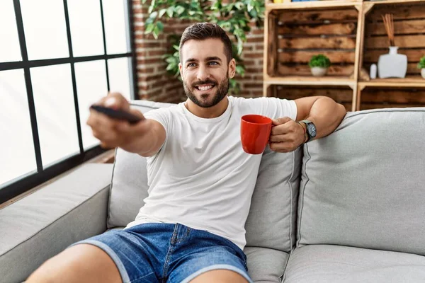 Young Hispanic Man Drinking Coffee Watching Home — Stock Photo, Image