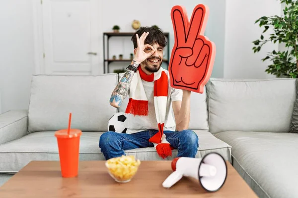 Hispanic Man Beard Supporting Football Team Home Sitting Sofa Smiling — Stockfoto