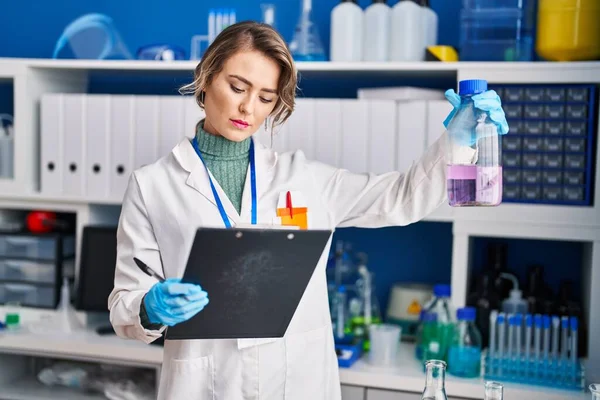 Young Woman Scientist Reading Report Holding Test Tube Laboratory — Foto de Stock