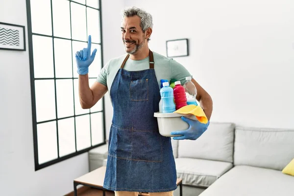 Middle Age Hispanic Man Wearing Cleaner Apron Holding Cleaning Products — Stock Photo, Image