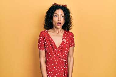 Yazlık elbise giyen genç Latin kız şaşkınlık ve şaşkınlık içinde ifade, korku ve heyecanlı yüz ifadesiyle şoka girdi.. 