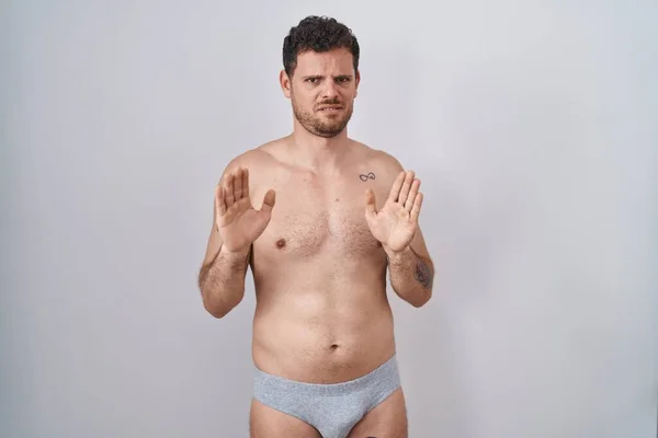 Young Hispanic Man Standing Shirtless Wearing Underware Moving Away Hands — Stock Photo, Image