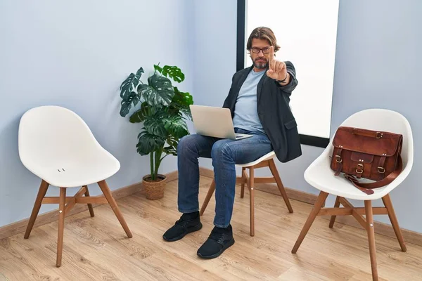 Handsome Middle Age Man Sitting Waiting Room Working Laptop Pointing — Stock fotografie