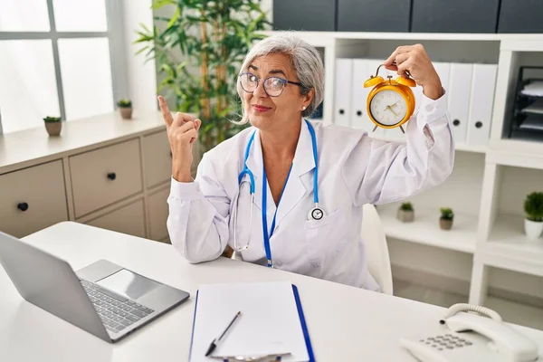 Middle Age Woman Grey Hair Wearing Doctor Uniform Holding Alarm — Stockfoto