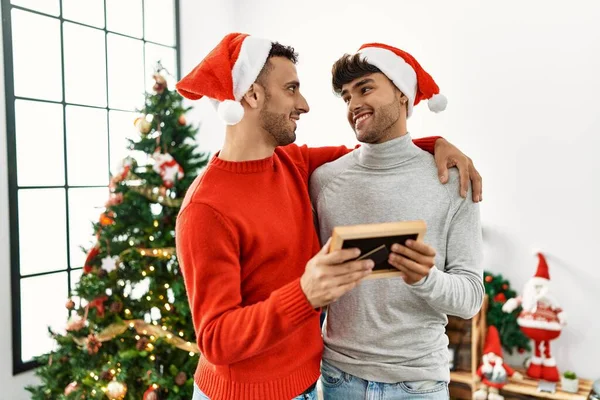 Two Hispanic Men Couple Looking Photo Hugging Each Other Standing — Stock Photo, Image