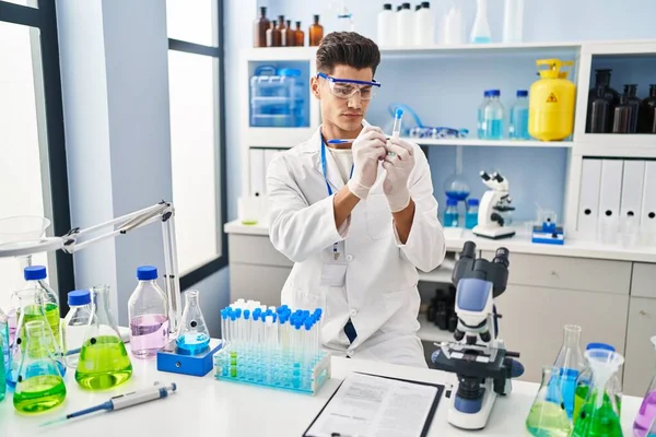 Giovane Uomo Ispanico Con Indosso Uniforme Scienziato Che Scrive Provetta — Foto Stock