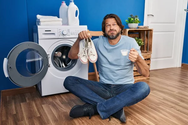 Handsome Middle Age Man Cleaning Sneakers Puffing Cheeks Funny Face — ストック写真