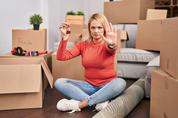 Blonde Woman Holding Keys New Home Sitting Floor Open Hand — Stok fotoğraf