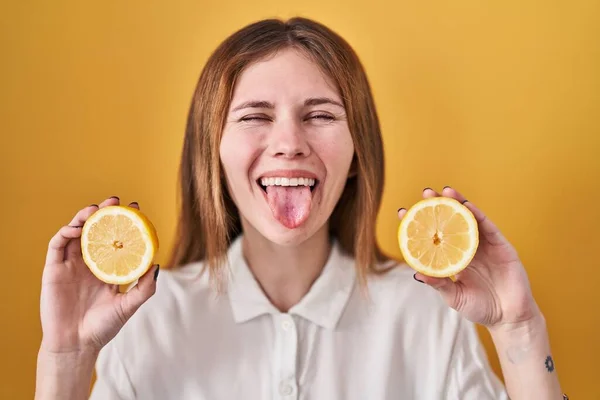 Beautiful Woman Holding Lemons Sticking Tongue Out Happy Funny Expression — Fotografia de Stock