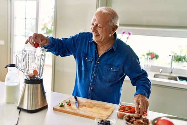 Senior Man Smiling Confident Putting Strawberry Blender Kitchen —  Fotos de Stock